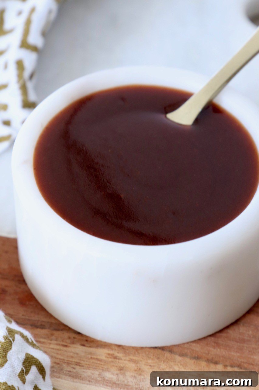 stir fry sauce in white bowl with small spoon