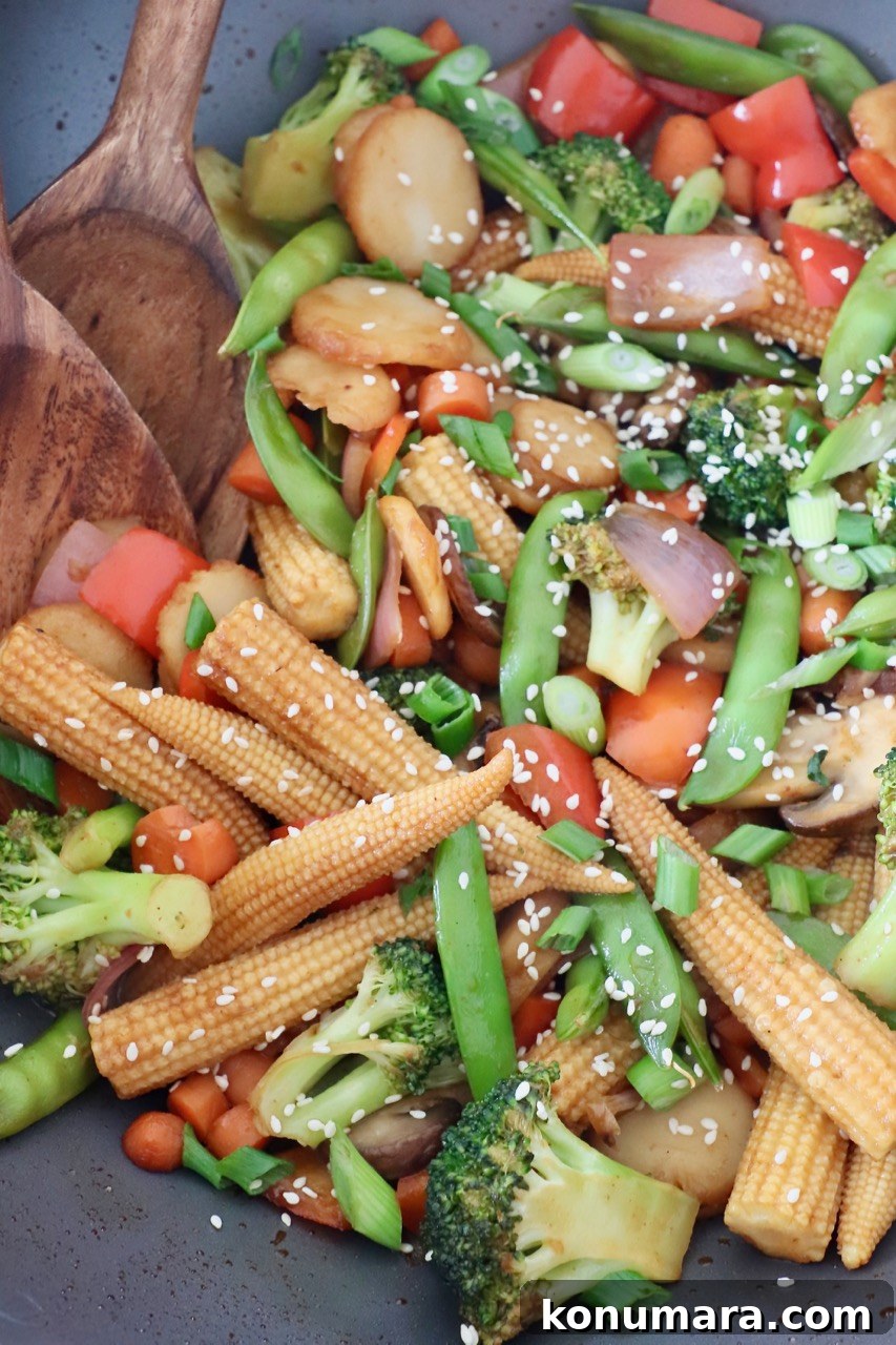 Crispy Garlic and Ginger Stir-Fried Vegetables Recipe 5 stir fry vegetables in wok with wooden spoon