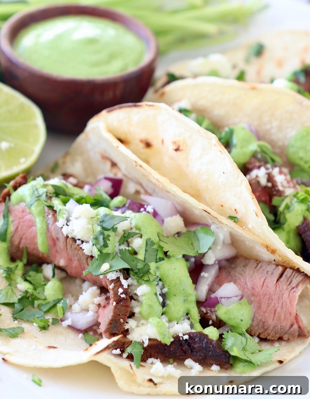 Zesty Cilantro Lime Sauce for Tacos and Grilled Meats 5 steak tacos on plate with cilantro lime sauce
