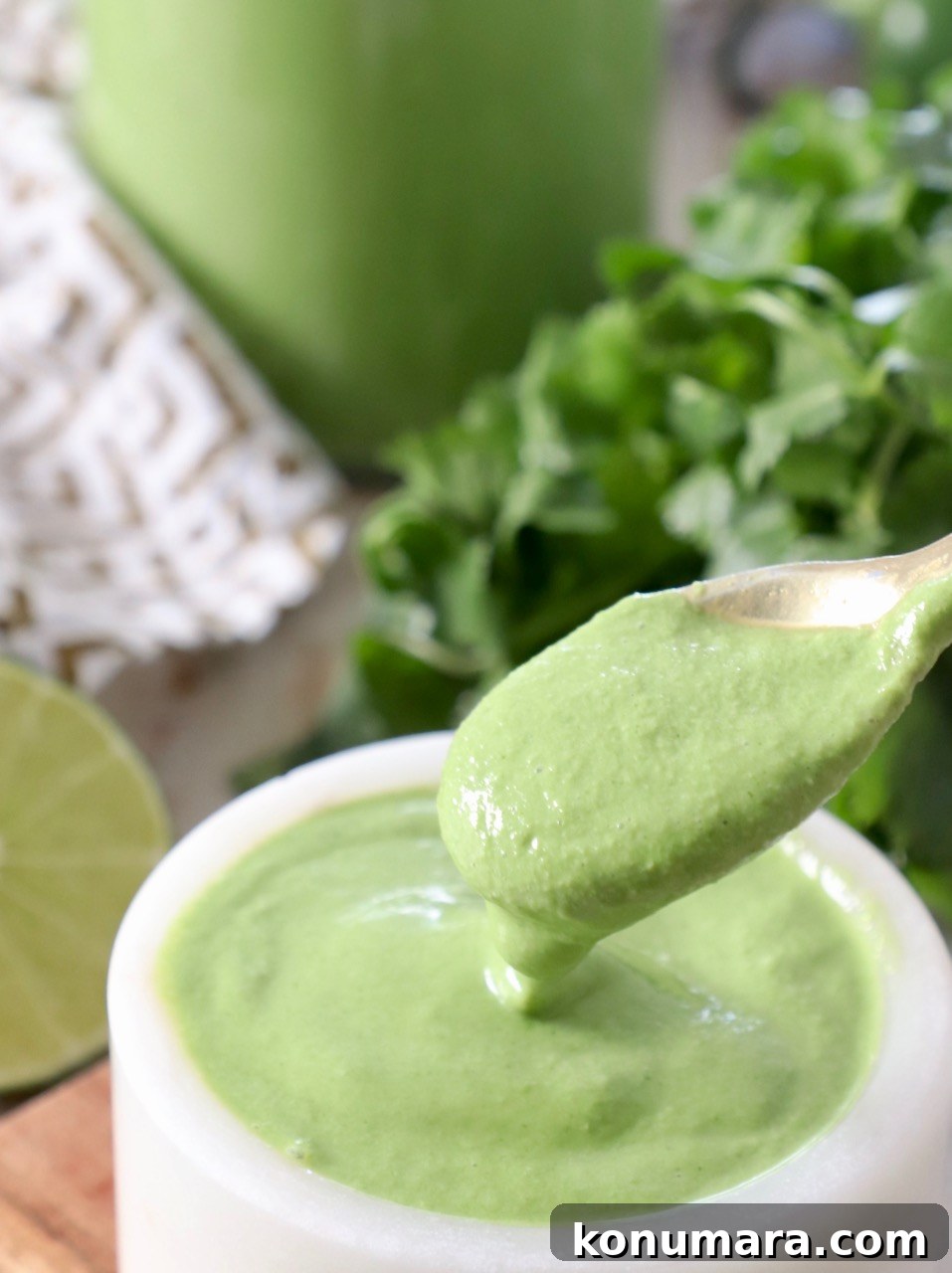 Zesty Cilantro Lime Sauce for Tacos and Grilled Meats 6 cilantro lime sauce on spoon in bowl