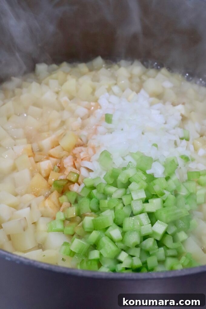 diced potatoes, onions and celery in a large pot with liquid