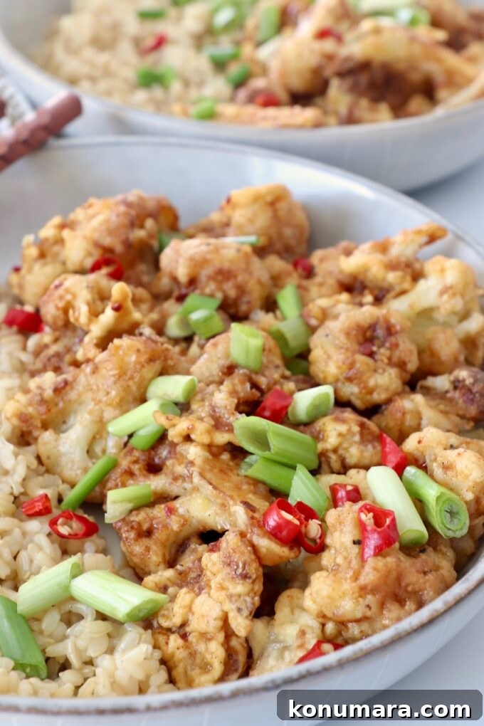 General Tso's Cauliflower Recipe: Crispy Sticky Sauce 5 fried cauliflower tossed with general tso's sauce in bowl with brown rice