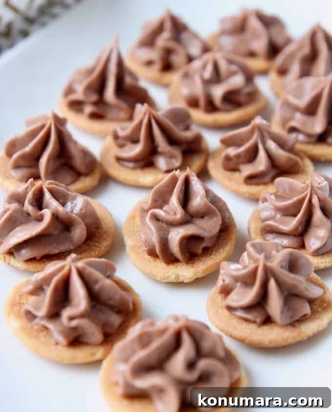 Nutella Cheesecake Bites Recipe 6 Nutella cheesecake piped onto vanilla wafers on plate