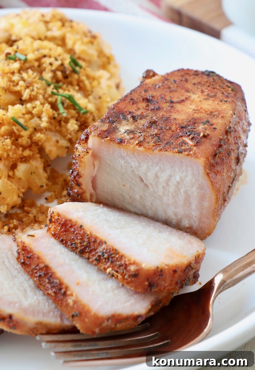 Sliced smoked pork chop on plate with mac and cheese