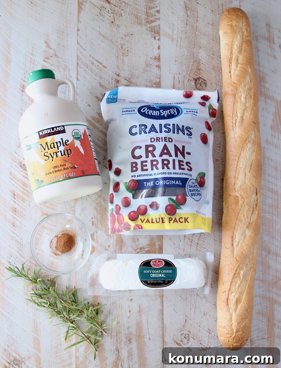 Ingredients for cranberry goat cheese crostini on a white wood board