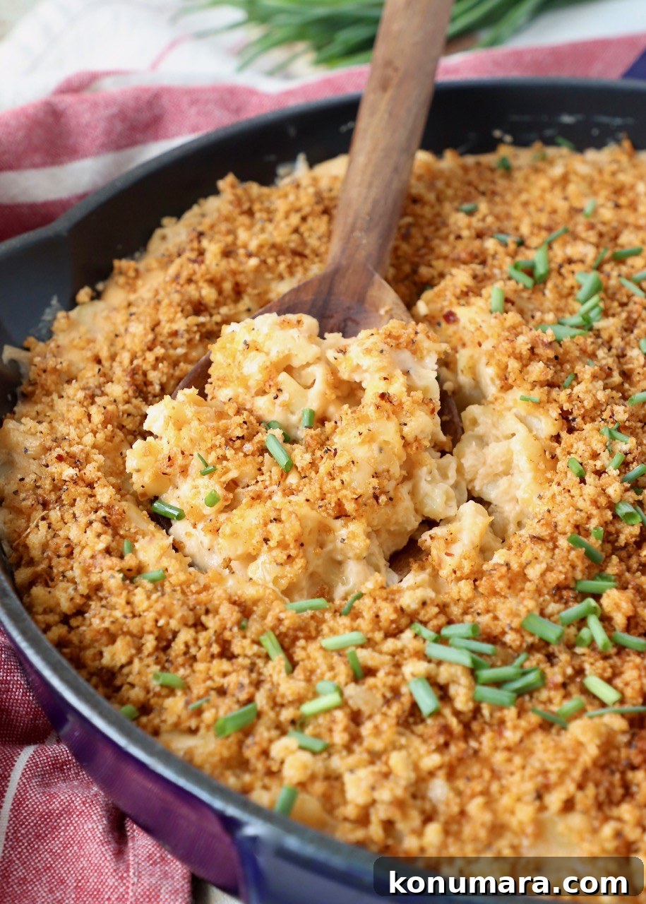 smoked mac and cheese in skillet with serving spoon