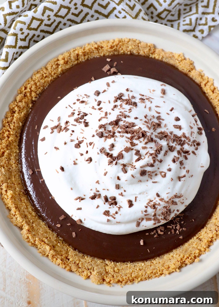 chocolate pie topped with whipped cream and chocolate shavings