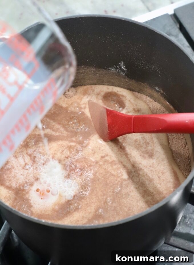 milk pouring into saucepan to make chocolate pie filling