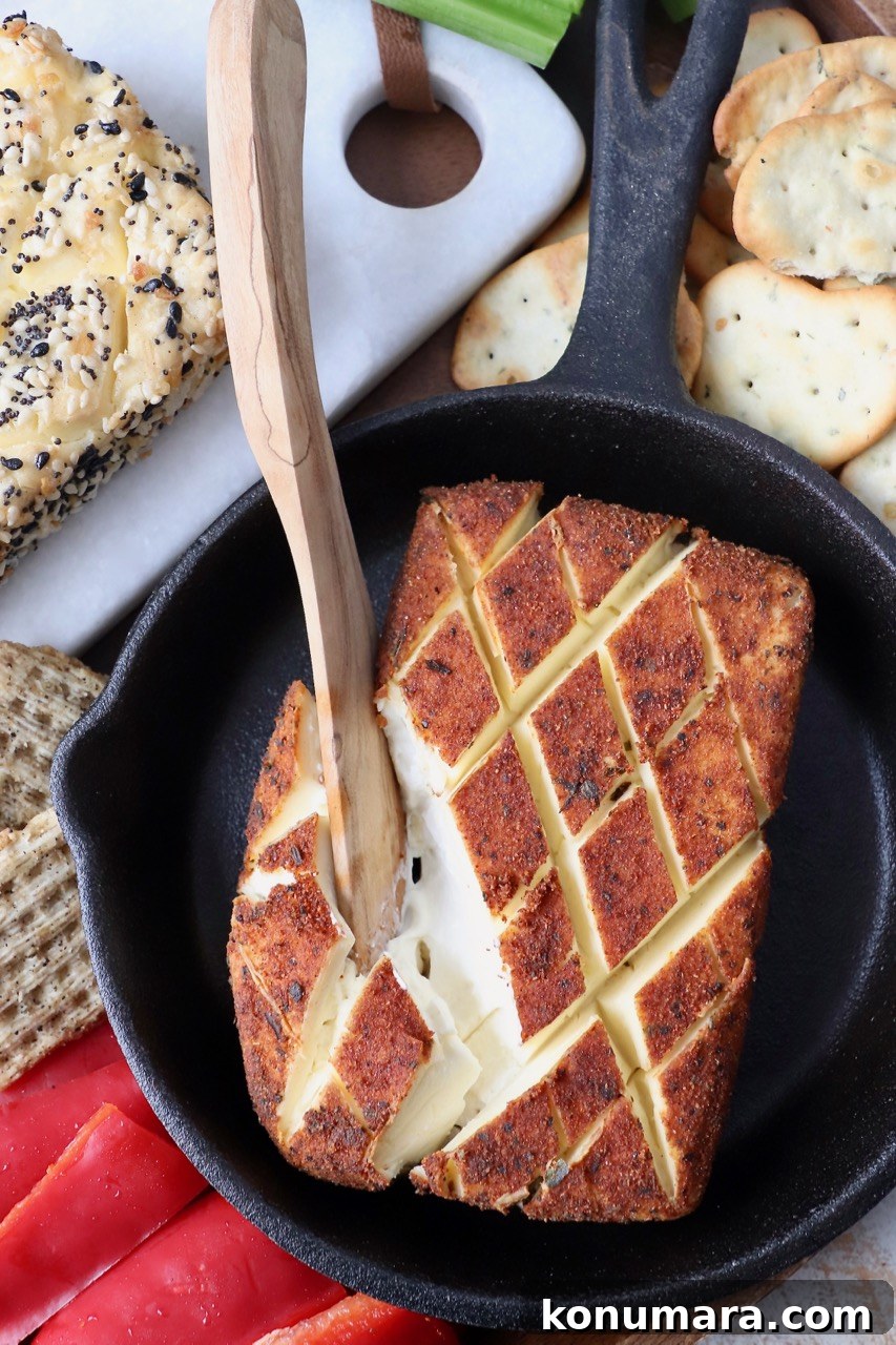 Smoked Cream Cheese Recipe and Serving Ideas 2 wooden knife in block of smoked cream cheese in cast iron skillet