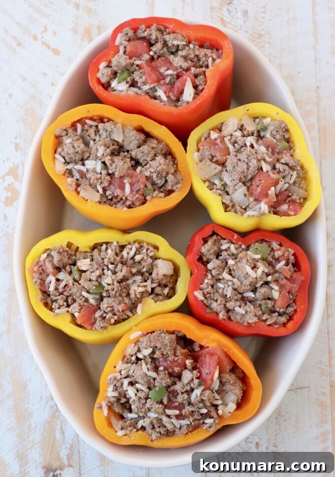 Stuffed bell peppers in oval casserole dish