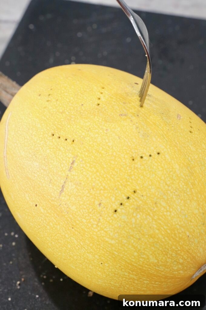 fork stuck in spaghetti squash to poke holes