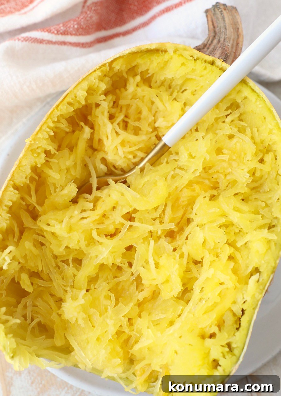 microwaved spaghetti squash half on plate with fork