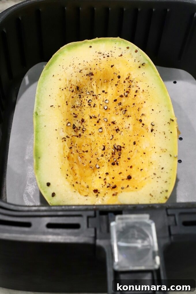 uncooked spaghetti squash half in air fryer