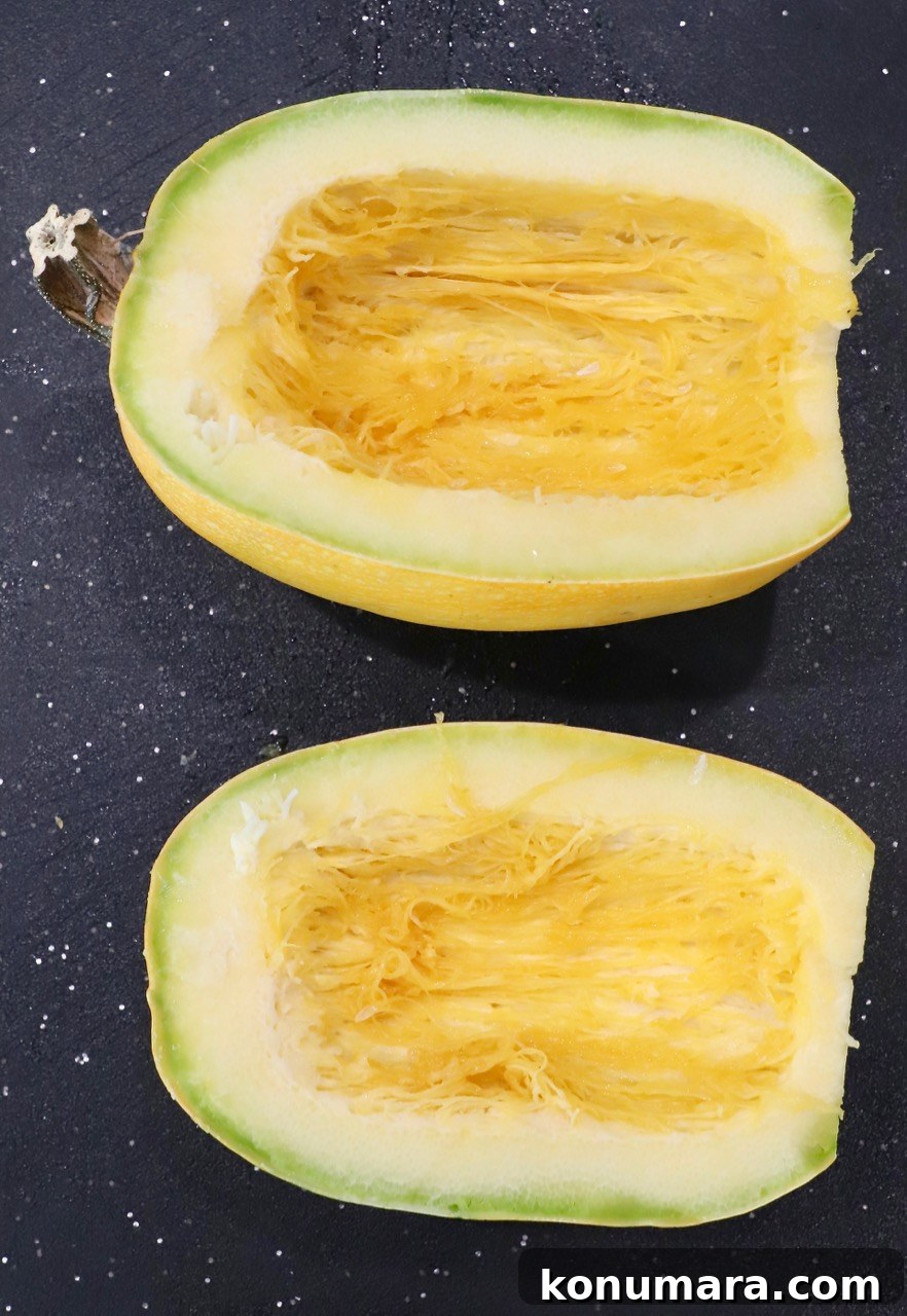 spaghetti squash cut in half on cutting board