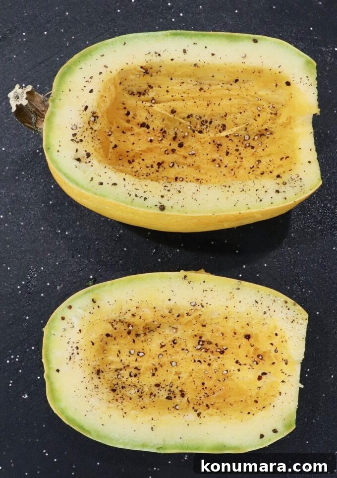 seasoned spaghetti squash halves on cutting board