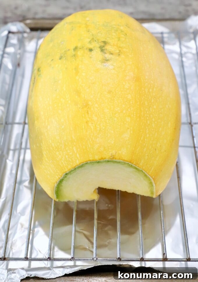 spaghetti squash cut in half on wire rack on top of baking sheet