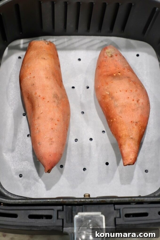 uncooked sweet potatoes in air fryer basket
