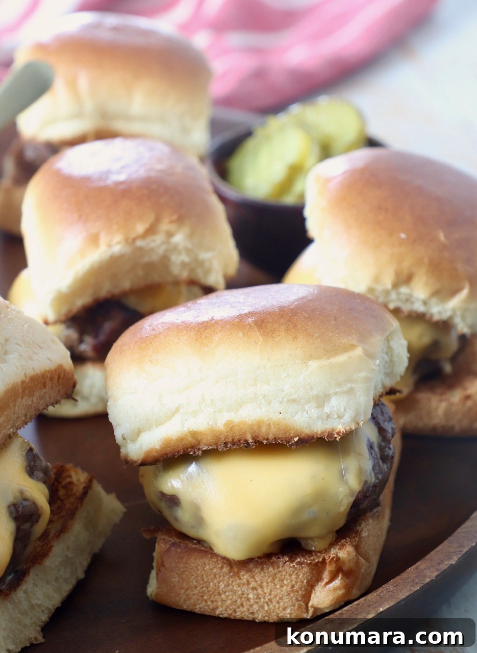 Juicy Cheeseburger Sliders Recipe with Caramelized Onions 2 cheeseburger sliders on serving tray