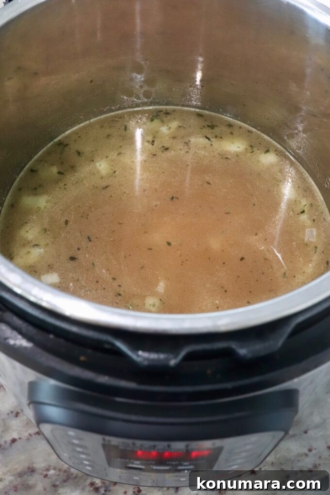 Creamy Instant Pot Risotto Recipe 6 chicken broth in Instant Pot with rice and onions