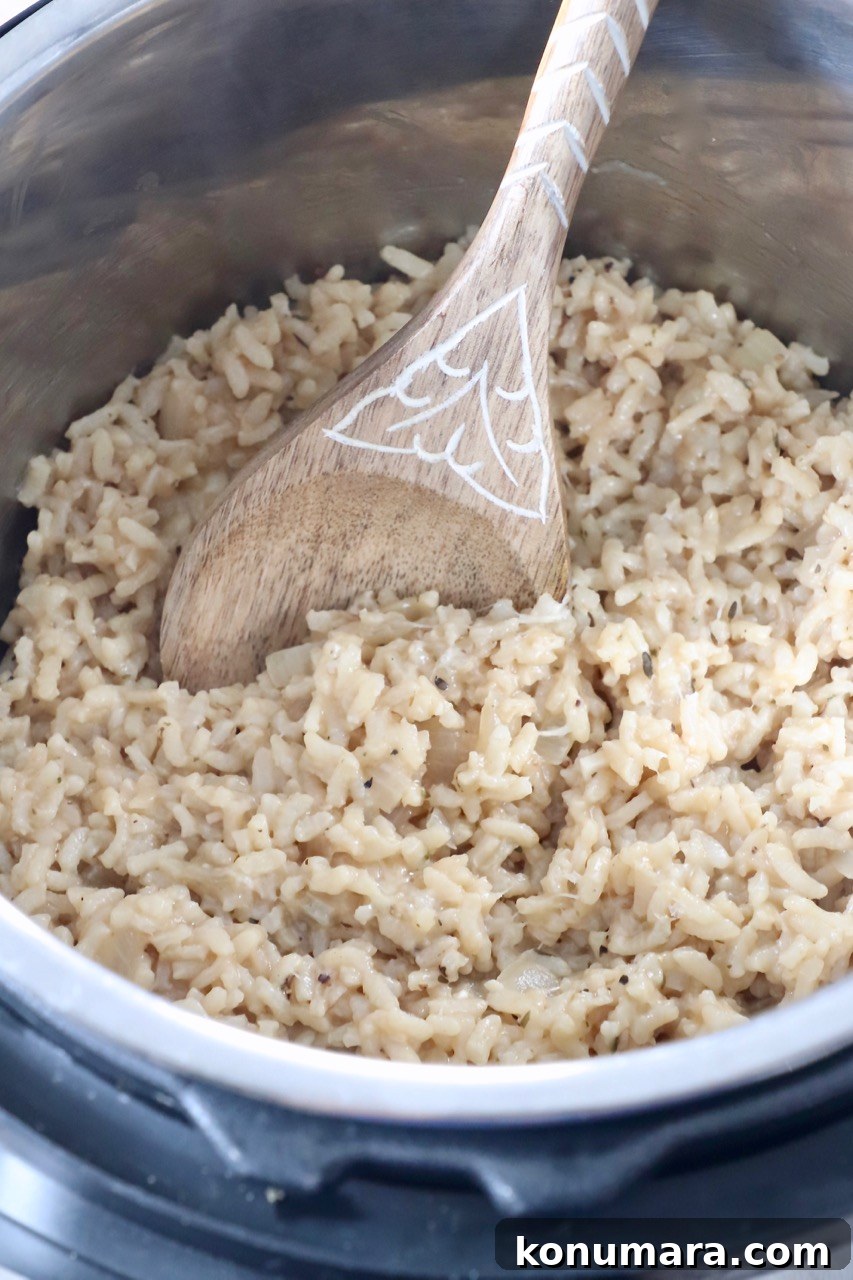 Creamy Instant Pot Risotto Recipe 9 cooked risotto in Instant Pot with serving spoon
