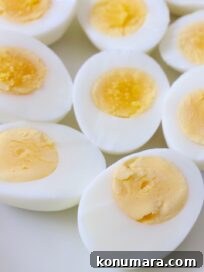 hard boiled eggs cut in half on white plate