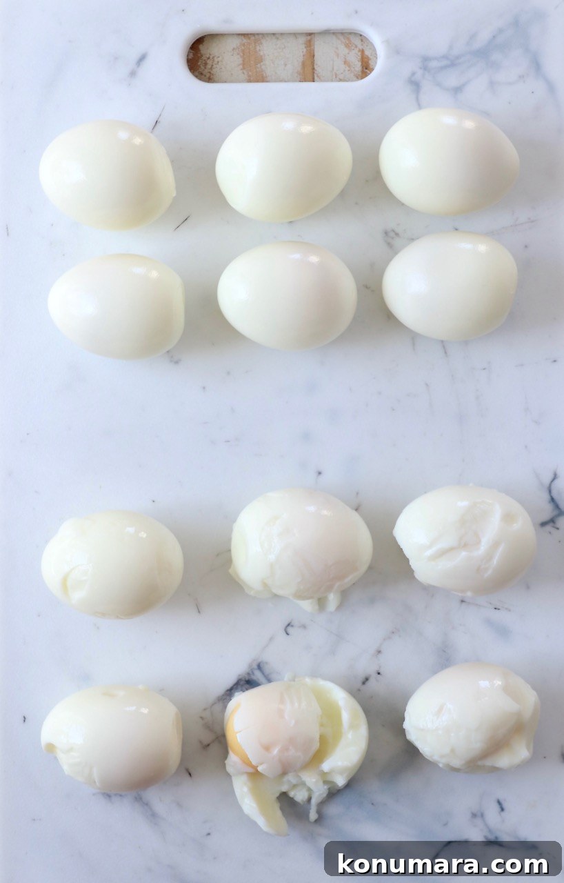 How to Hard-Boil Eggs: Foolproof Method for Perfect Yolks 7 peeled hard boiled eggs on cutting board