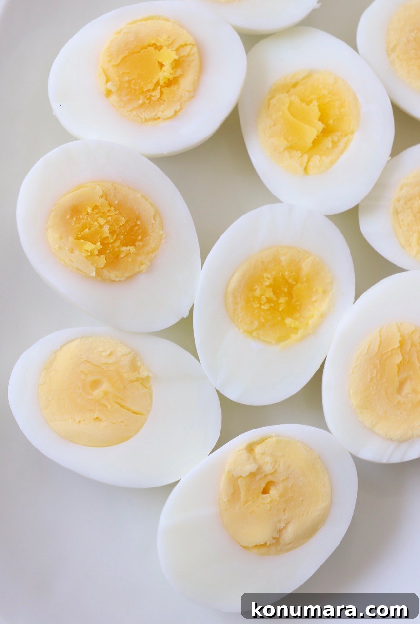 How to Hard-Boil Eggs: Foolproof Method for Perfect Yolks 8 hard boiled eggs cut in half on plate