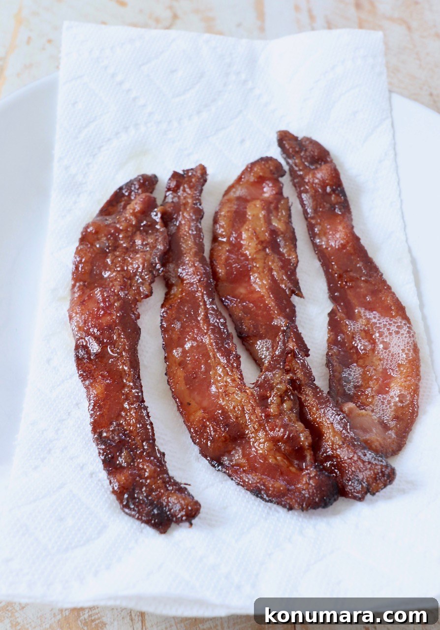 How to Cook Bacon in the Oven for Crispy, Even Results 6 cooked bacon on paper towel lined plate