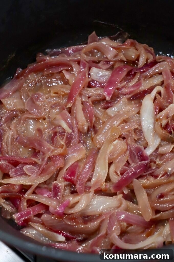 Caramelizing Onions: Step-by-Step Guide 11 sliced onions caramelizing in pot on stove