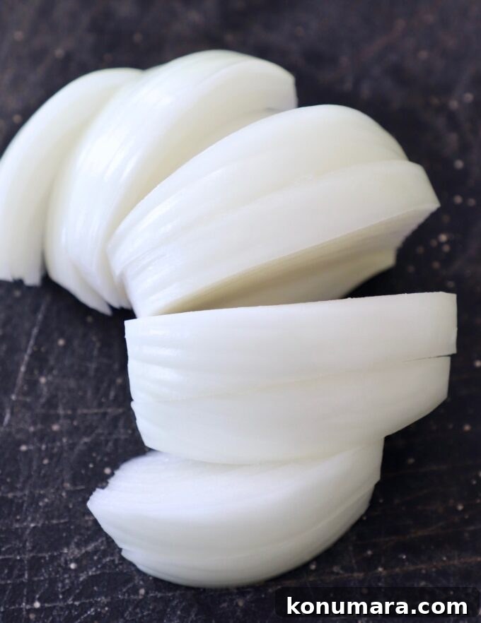 Caramelizing Onions: Step-by-Step Guide 6 slices of onion on cutting board