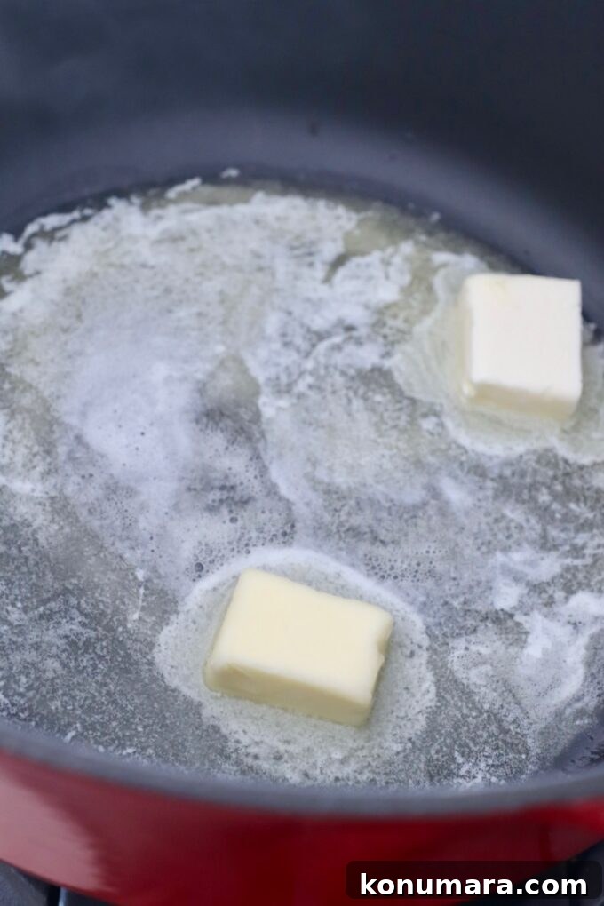 Caramelizing Onions: Step-by-Step Guide 8 butter melting in cast iron pot
