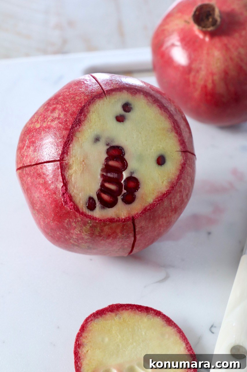 fresh pomegranate cut on cutting board