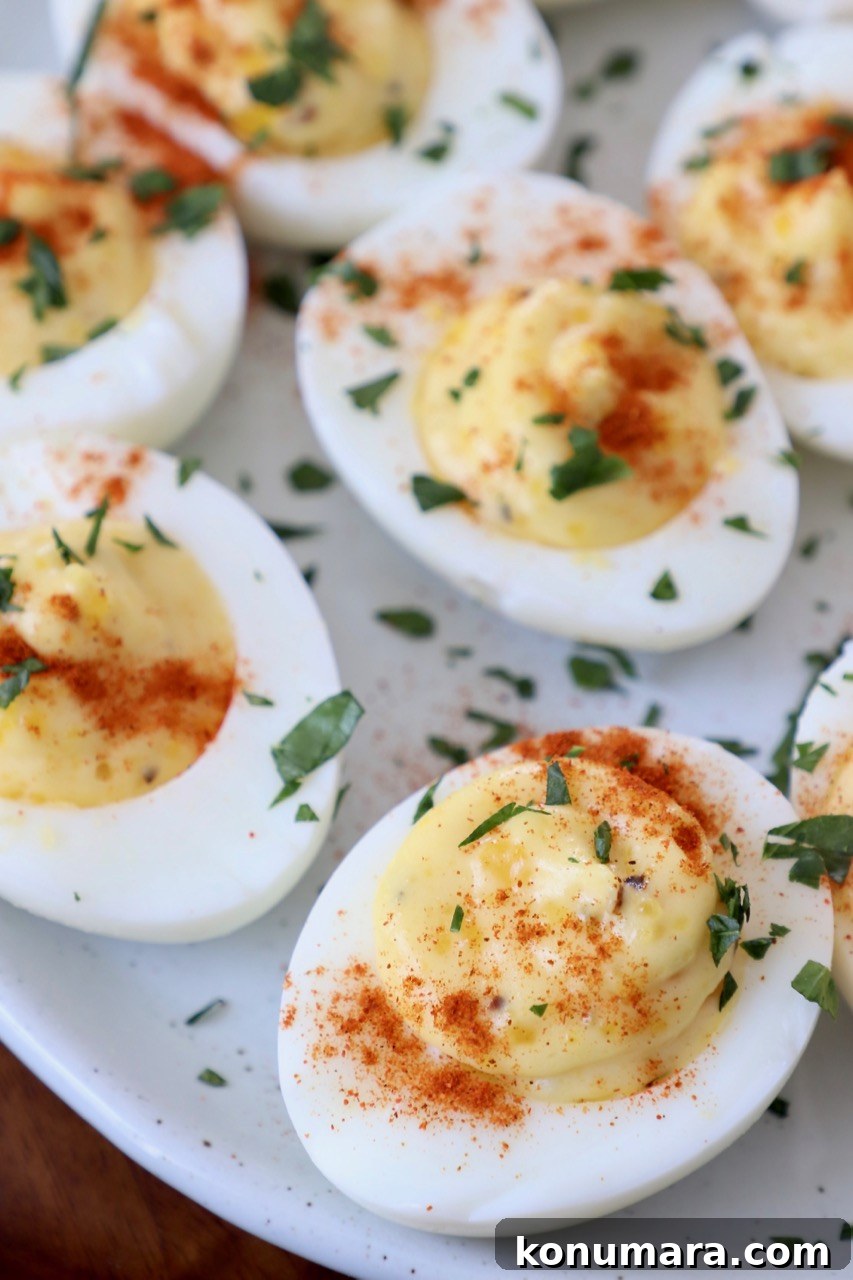 deviled eggs on plate topped with fresh chopped parsley