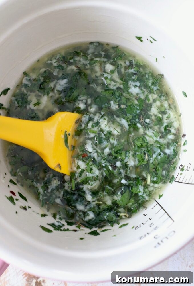 Crispy Garlic Bread with Herbed Butter 6 melted butter with herbs and seasonings in a bowl with a spatula