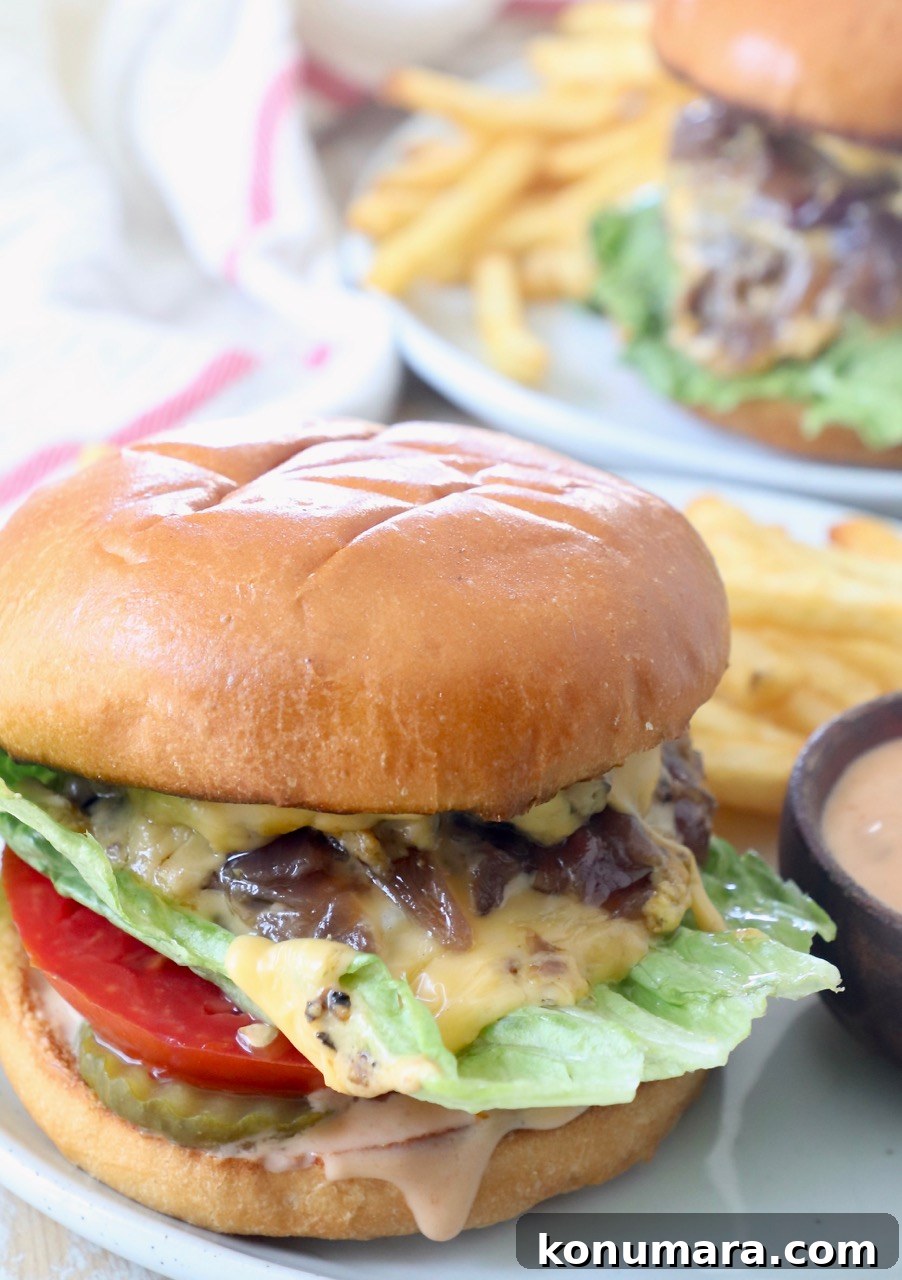 Animal-Style Burger Recipe: In-N-Out Copycat 11 cheeseburger on plate with fries and sauce