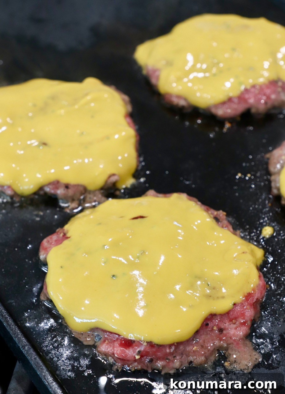 Animal-Style Burger Recipe: In-N-Out Copycat 6 mustard covered burger patties on cast iron griddle