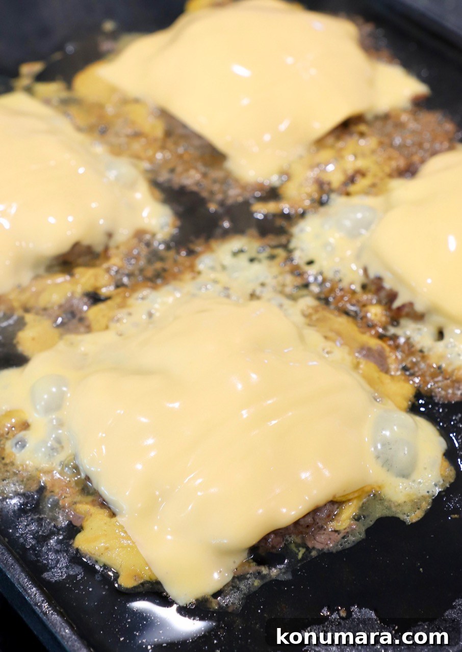 Animal-Style Burger Recipe: In-N-Out Copycat 8 cheese covered burger patties at griddle