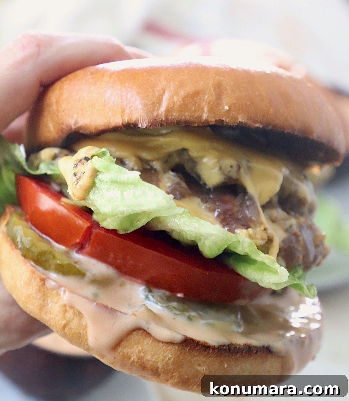 Animal-Style Burger Recipe: In-N-Out Copycat 10 hand holding animal style burger