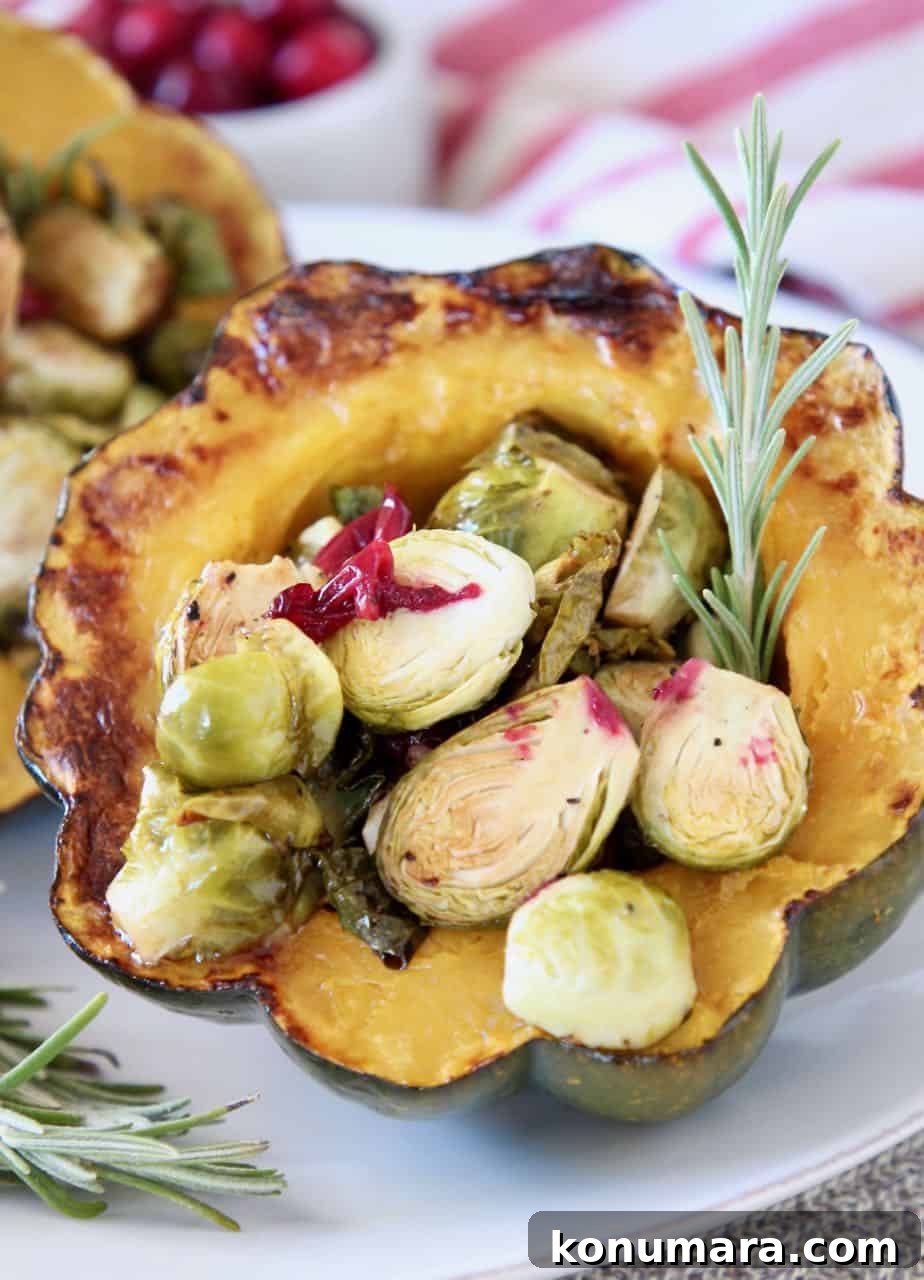 stuffed acorn squash half filled with roasted brussels sprouts and cranberries