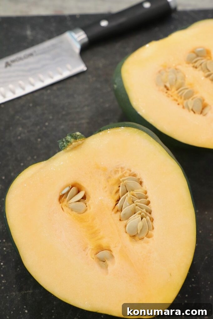 acorn squash sliced in half on cutting board