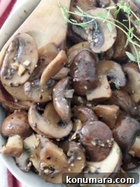 sauteed mushrooms in bowl with wooden spoon