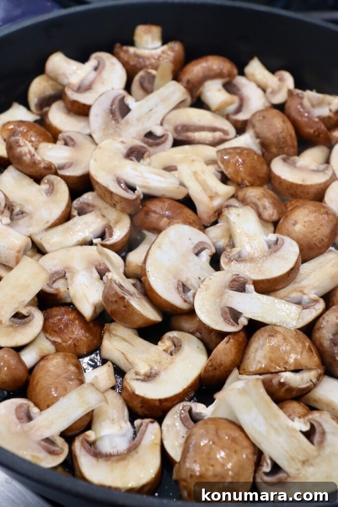 Garlic Butter Sauteed Mushrooms with Herbs 5 sliced mushrooms in skillet