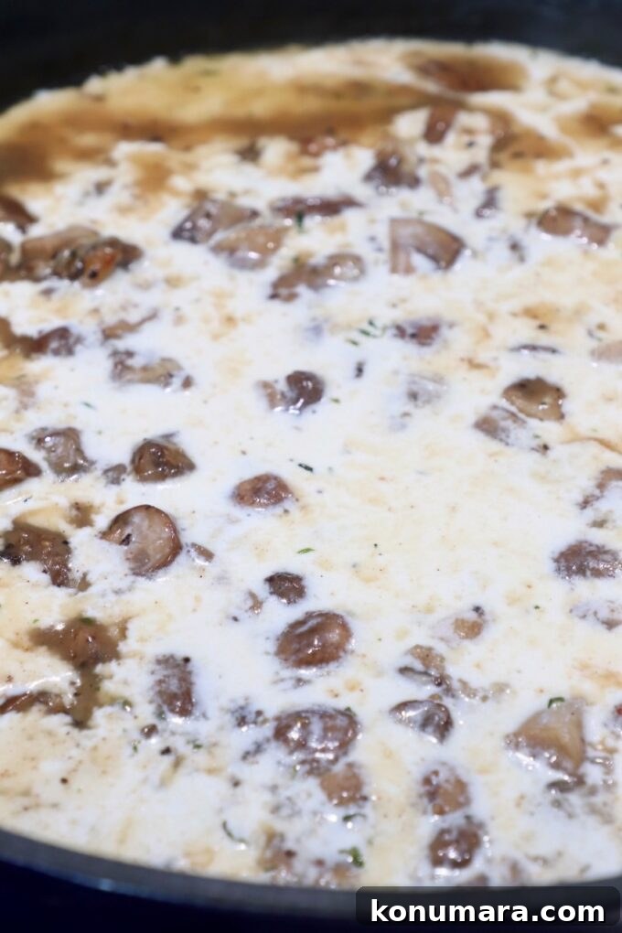 Velvety Cream of Mushroom Soup Recipe 7 diced mushrooms in creamy sauce in skillet