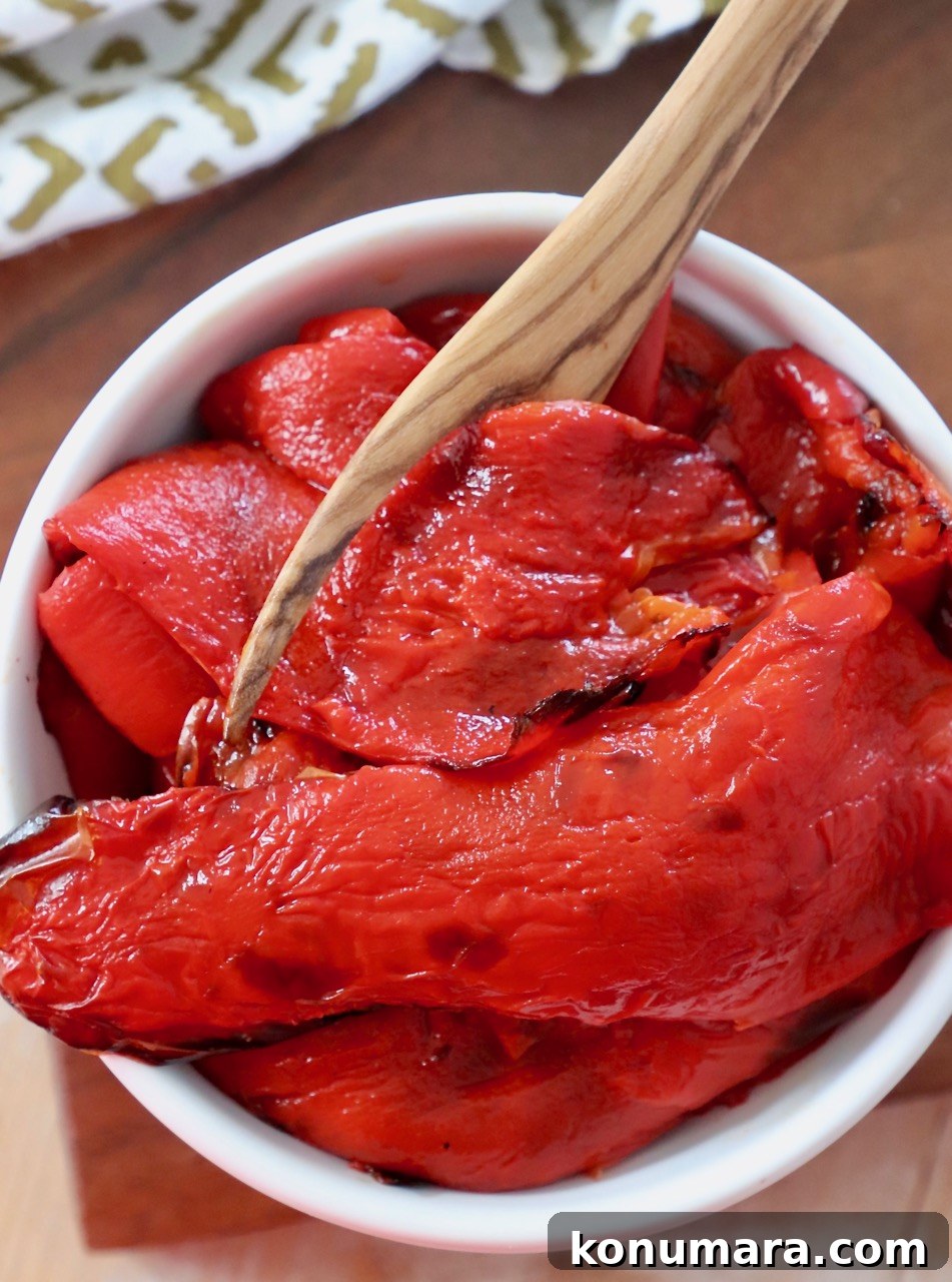 roasted red peppers in bowl with wooden fork