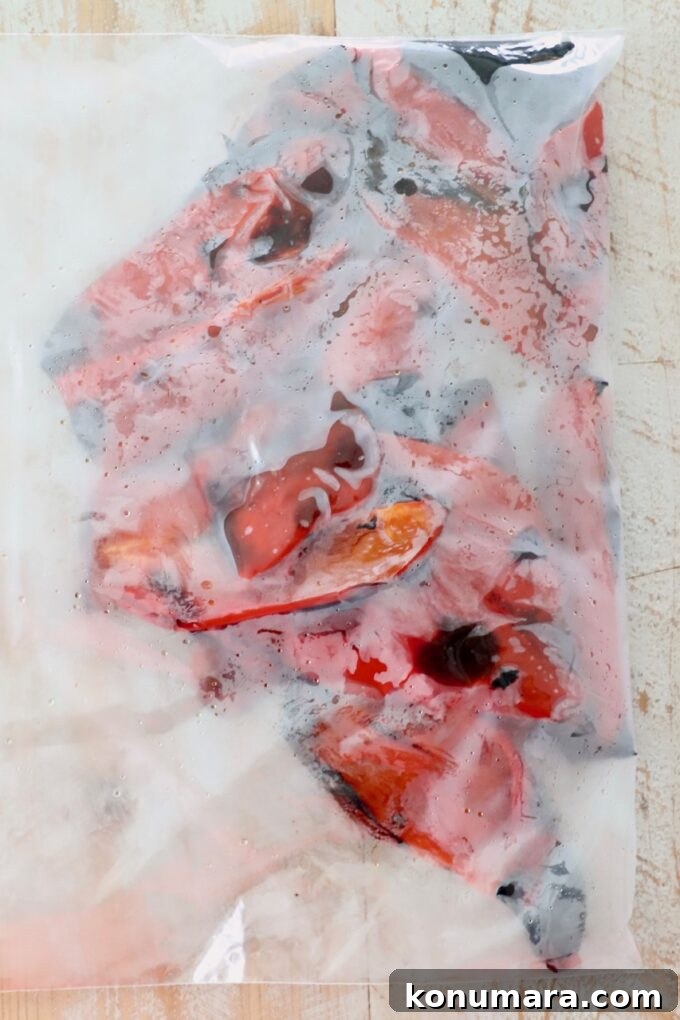 roasted red peppers steaming in zipper plastic bag