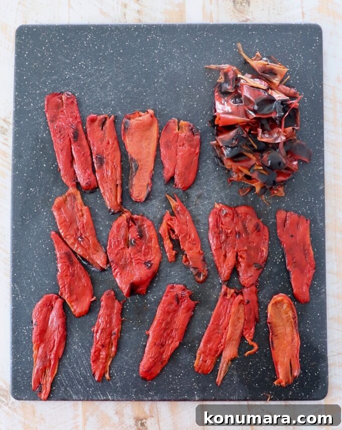 strips of peeled roasted red peppers on cutting board