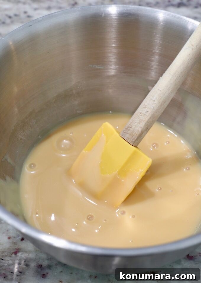 condensed milk in bowl mixed with vanilla extract