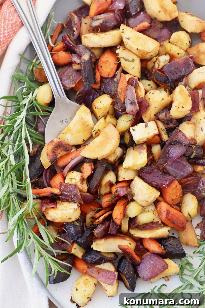 Oven-Roasted Root Vegetables with Garlic and Herbs 2 Roasted root vegetables on a plate with rosemary
