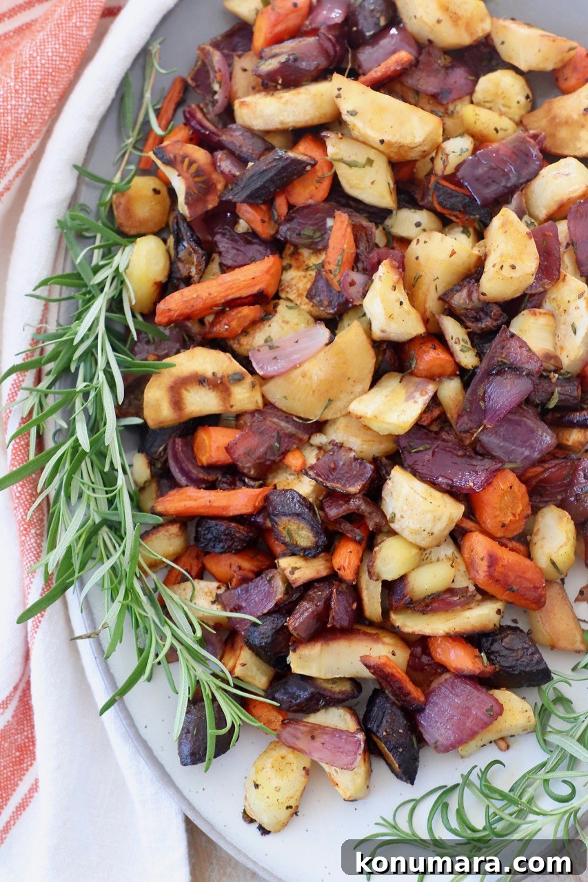 Oven-Roasted Root Vegetables with Garlic and Herbs 6 Roasted root vegetables on a plate with rosemary sprigs