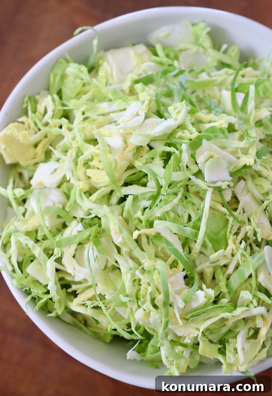 How to Shred Brussels Sprouts for Salads and Slaws 11 shredded brussels sprouts in white bowl